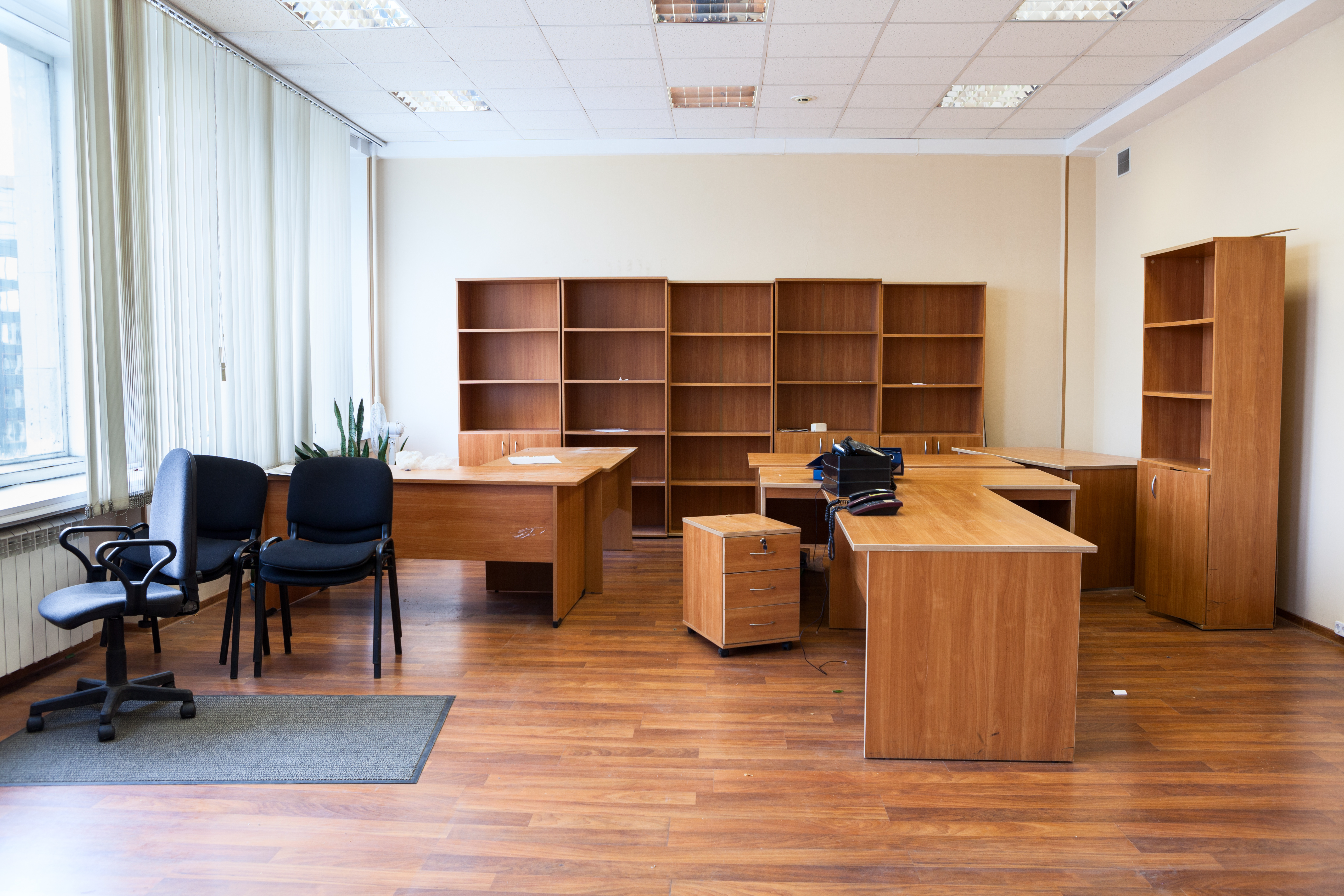 Leeres Büro mit Schreibtischen, Stühlen und Regalen – Symbol für Büroauflösung, Entrümpelung und fachgerechte Entsorgung.